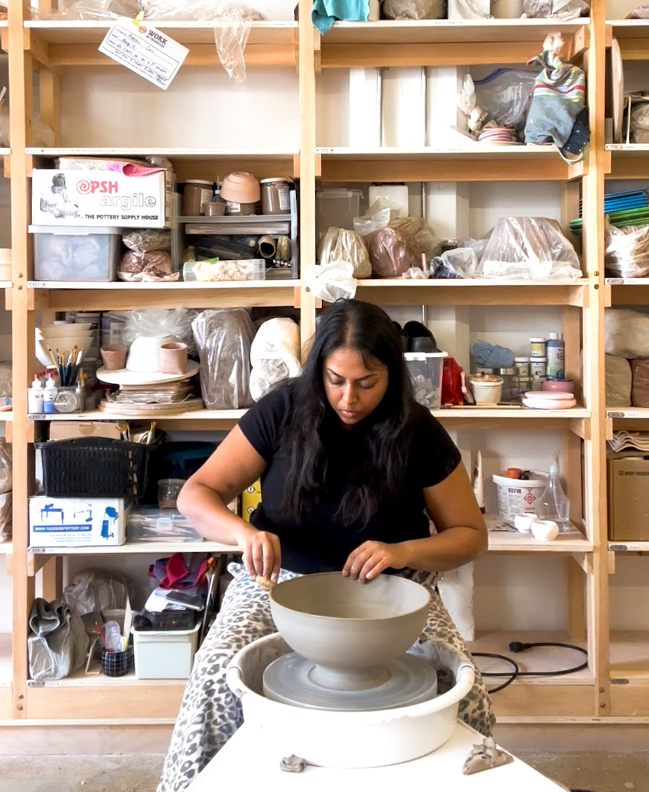 Piya at the wheel in her ceramics studio